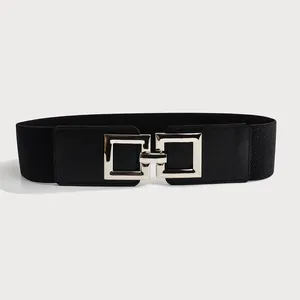 Close-up of a wide black elastic belt with a stylish silver interlocking square buckle
