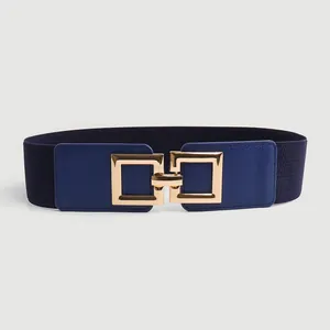 Detail view of a navy blue elastic belt with a polished gold interlocking square buckle