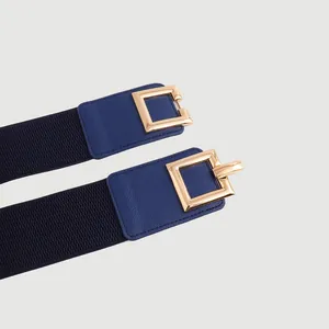 Close-up detail of a golden square buckle on a navy blue elastic waist belt strap
