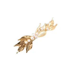 Detailed view of the gold leaf texture and white pearl inlay on the hair clip