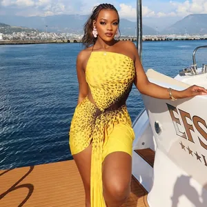 Leopard print diagonal neck cutout mini dress worn on a yacht for a summer vacation look.