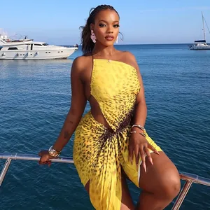 Sexy yellow leopard print asymmetric bodycon mini dress with ruched details on a luxury yacht.