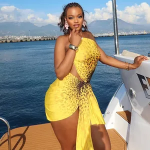 Vibrant yellow leopard print one-shoulder cut-out mini dress with ruched detail.