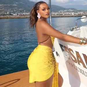 Stunning yellow leopard print backless mini dress with an irregular pleated wrap skirt