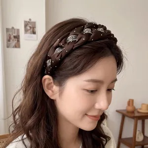 Close-up view of an elegant hand-woven dark brown headband with sparkling rhinestone details