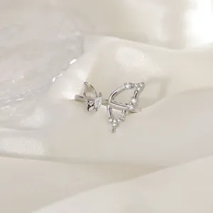 Detailed macro shot of an asymmetrical silver butterfly ring inlaid with white zircons