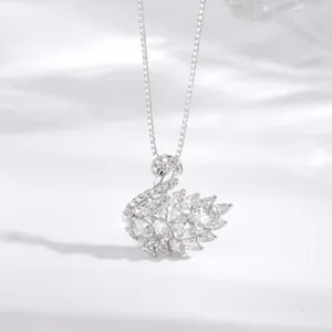 Close-up detail of an elegant sparkling swan pendant necklace with silver finish