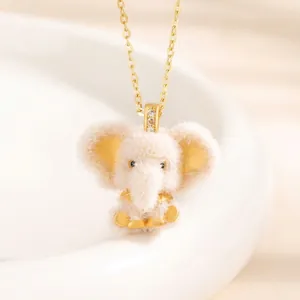 Detailed view of a cute white fuzzy elephant pendant with gold accents on a necklace