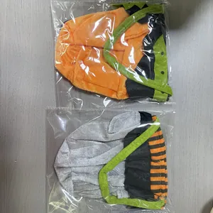 Detail view of Halloween witch and pumpkin plush candy bags in plastic packaging