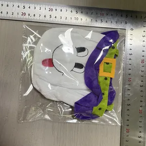 Detail view of Halloween ghost candy bag with a metal ruler showing product dimensions