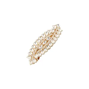 Macro detail of elegant leaf-shaped hair clip featuring sparkling teardrop-cut crystals