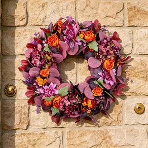 Autumn Thanksgiving artificial peony and hydrangea wreath hanging on a textured stone wall