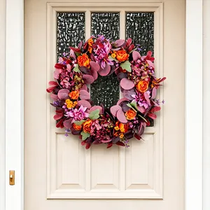 Handcrafted autumn Thanksgiving wreath with peony and hydrangea on a cream door.