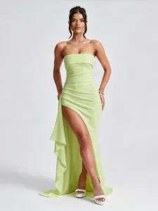 Full view of elegant lime green strapless maxi dress with a daring side slit and ruffles.
