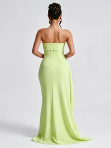 Back view of an elegant lime green strapless maxi dress with side drape and zip