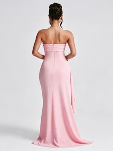 Back view of an elegant pink strapless maxi dress with sophisticated side ruffle detail
