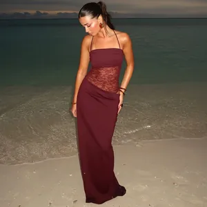 Elegant maroon lace patchwork long dress with spaghetti straps on a beach