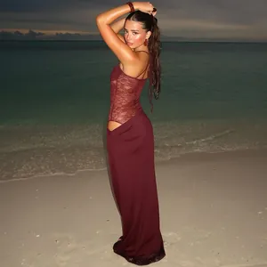 Elegant wine red lace patchwork camisole maxi dress with cutout detail on the beach