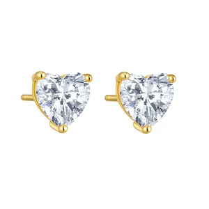 Close-up detail of elegant gold-plated heart-shaped cubic zirconia stud earrings.