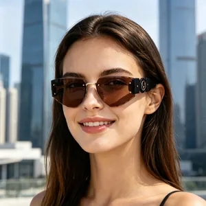 Close-up of a model wearing stylish frameless diamond-cut sunglasses with brown lenses.