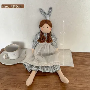 Handmade Korean style cloth doll wearing a checkered dress and white apron with bunny ears.