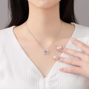 Exquisite silver butterfly pendant necklace with purple stone worn on a model's neck