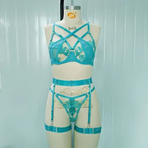 Intricate turquoise floral lace lingerie set with strappy details and garter belt