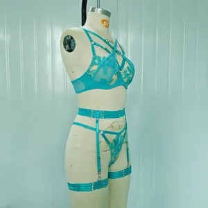 Close-up detail of a turquoise lace embroidery lingerie set on a display mannequin
