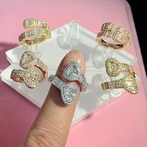 Macro detail of trendy hip-hop open heart ring featuring sparkling baguette zircons