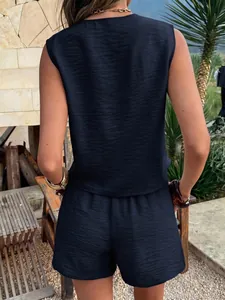Back view of navy blue two-piece vacation set with textured sleeveless top and shorts