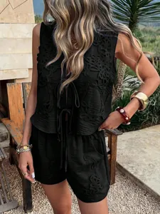 Detail shot of a black sleeveless vest and shorts two-piece set with intricate embroidery.