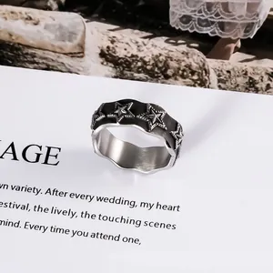 Vintage stainless steel star ring with black enamel finish for unisex fashion styling.