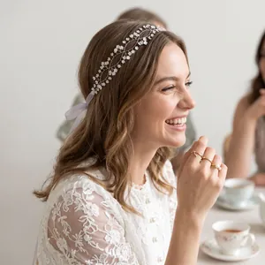 Close-up of a smiling bride wearing a double-layer hand-woven floral headband with white lace
