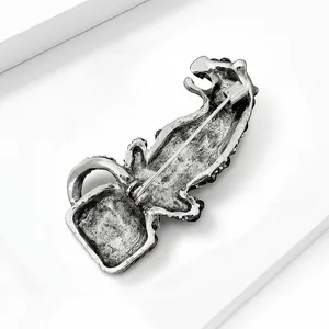 Back view of vintage silver leopard brooch showing secure alloy pin clasp mechanism