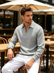 Close-up of men's grey half-zip jacquard sweater in a stylish outdoor cafe setting