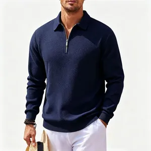 Close-up of men's navy blue jacquard polo sweatshirt with half-zip and ribbed cuffs
