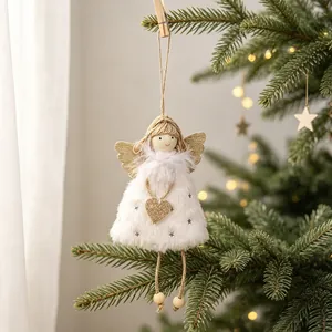 Detailed view of a white plush Christmas angel doll ornament on a pine tree branch
