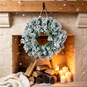 Snowy green Christmas wreath decoration for holiday home fireplace or door hanging