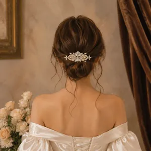 Elegant bridal hair comb with pearls and rhinestones shown on a vintage wedding updo.