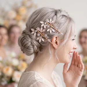 Detail view of vintage gold leaf hair pins with rhinestones in a bridal hairstyle.