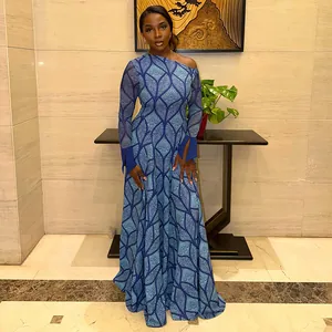 Elegant one-shoulder blue patterned maxi dress worn by model in upscale setting