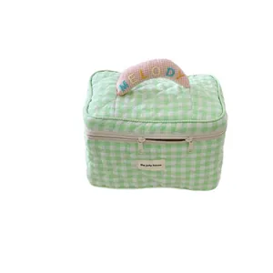 Large green and white checkered quilted cosmetic bag for makeup storage and travel