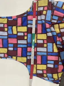 Detailed view showing the vertical length measurement of the geometric print dress.
