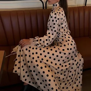 Elegant vintage style polka dot maxi dress featuring puff sleeves and lace cuff detailing