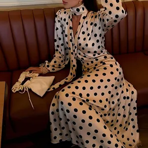 Elegant vintage puff sleeve long dress with black polka dots and matching neck scarf detail