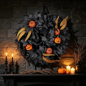 Atmospheric Halloween black maple leaf wreath with orange pumpkins and gold feather accents