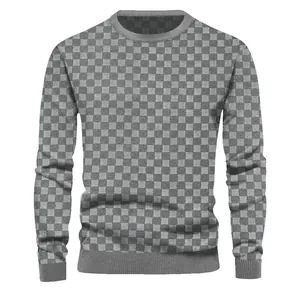 Detailed view of the gray jacquard checkerboard pattern on a men's crew neck sweater