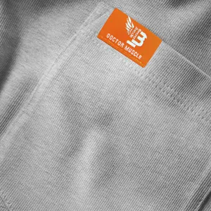 Close-up of grey textured fabric and orange woven label on a men's casual short sleeve top.