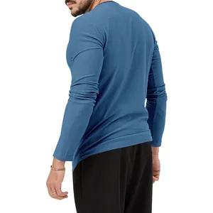A side view of a men's slim-fit long-sleeve T-shirt in solid blue, premium cotton fabric
