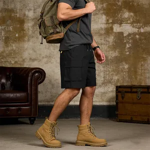 Detail view of men's black outdoor cargo shorts paired with hiking boots and backpack
